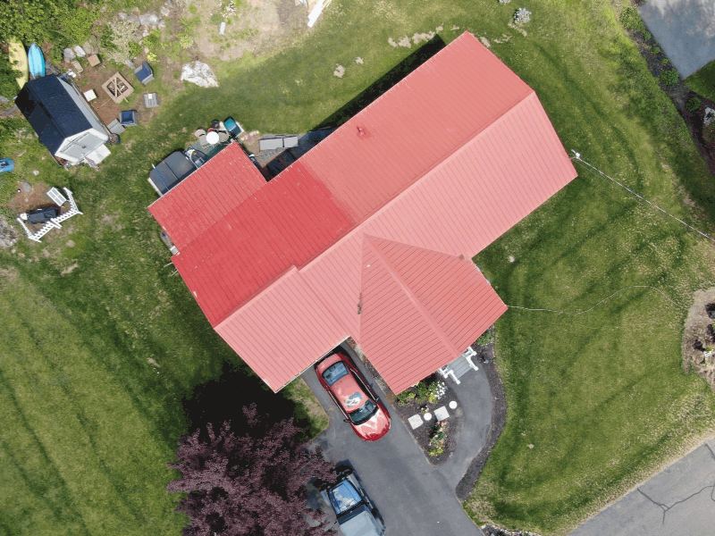 Aerial view of a standing-seam metal roof with concealed fasteners running the full length of each panel